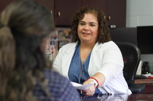 Intake Care Manager meeting with a New Human Services Client at her desk