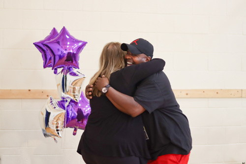 Two UCC Human Services Clients Hugging at award ceremony