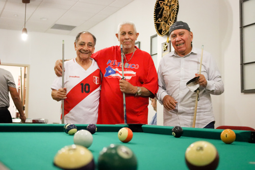 Photo of Male Senior Center Clients playing pool in the UCC Senior Center
