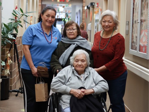 Photo of UCC Senior Center clients smiling in the entryway