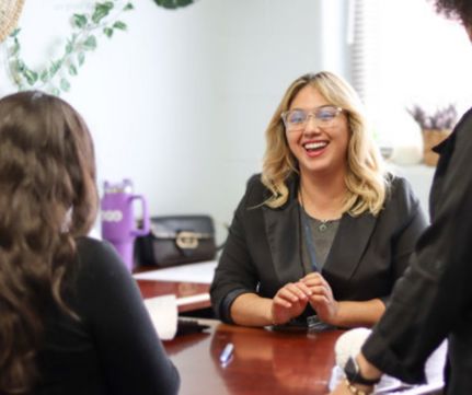Program counselor welcoming new patient at her desk