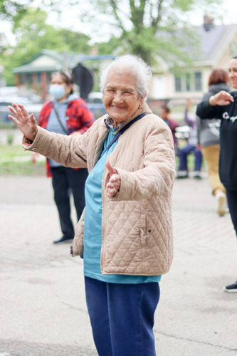 Photo of Senior Center client walking and dancing in Walker's Square Park