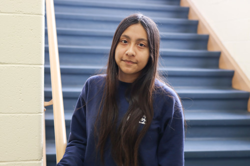 Adamarys standing in the school hallway smiling