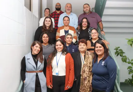 Family Care team members posing for the camera on building stairs