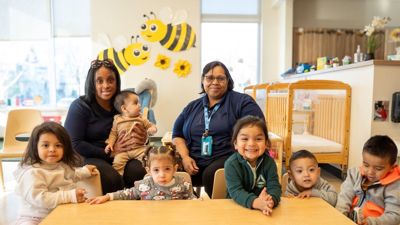 UCC Early Learning Academy Teachers in the classroom with students at a table